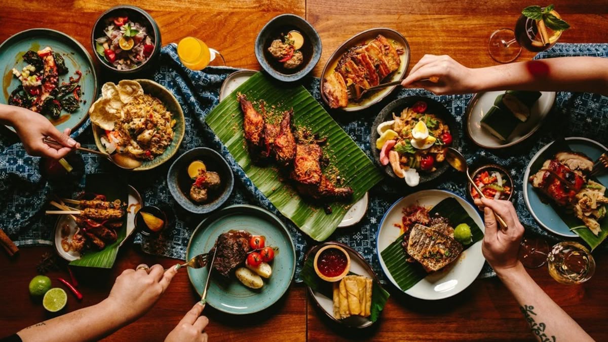 Family and friends sharing a variety of Thai dishes around a dining table