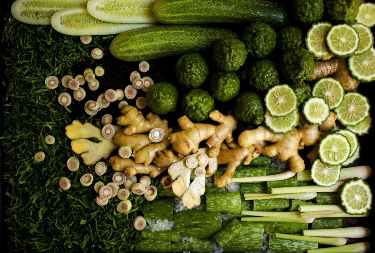 Fresh Thai herbs and aromatics including lemongrass, Thai basil, galangal, garlic, and chilies