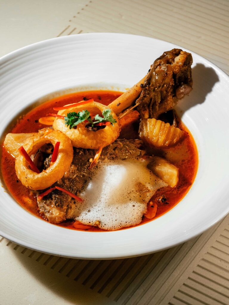 Lamb Shank Massaman slow-cooked with Thai herbs and spices