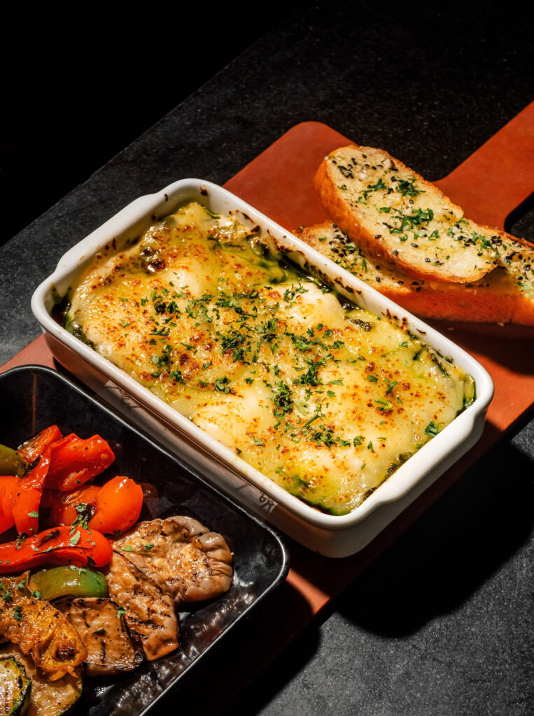 Baked Lasagna with grilled vegetables and garlic bread at Indulge Bangkok