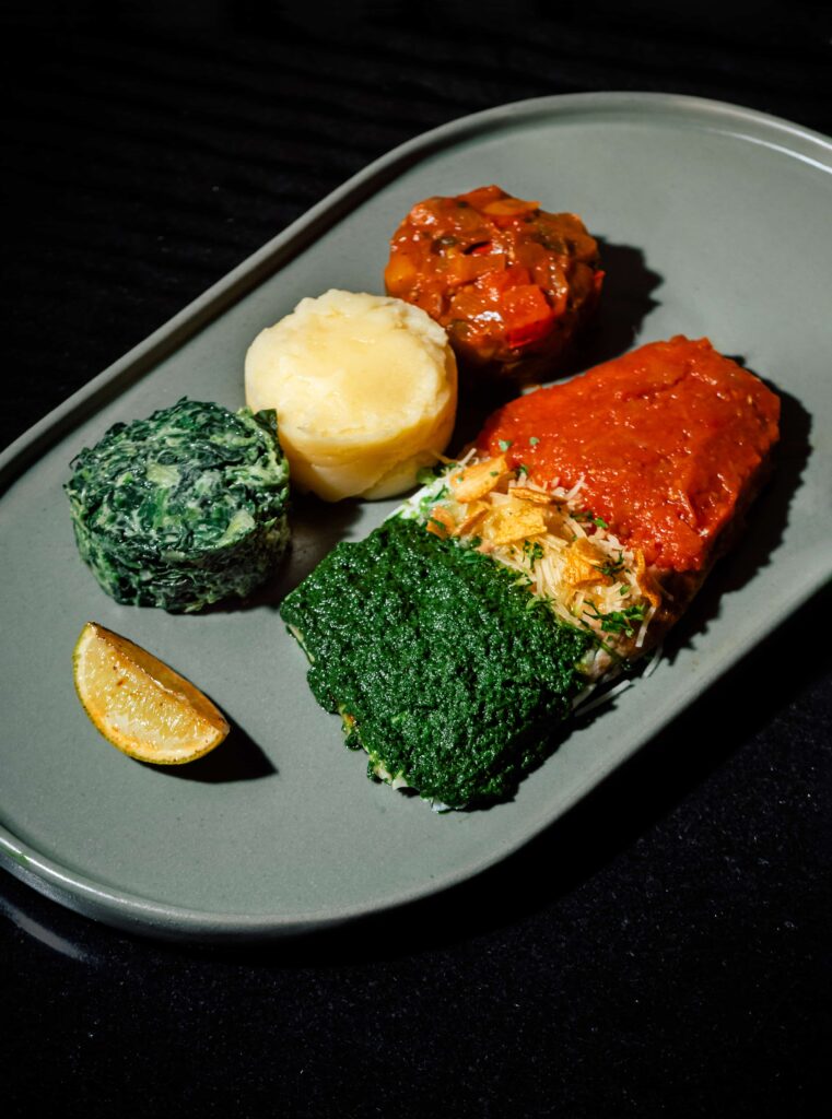 Baked Seabass with lemon butter, pesto and tomato sauce